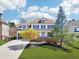 Charming two-story home with a well-manicured lawn, colorful tree and inviting front porch at 3530 Horizon Ct, Cumming, GA 30041