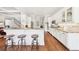 Kitchen featuring hardwood floors, white cabinets, granite countertops, a breakfast bar and stainless steel appliances at 3530 Horizon Ct, Cumming, GA 30041