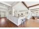 Kitchen features white cabinets, a breakfast bar, hardwood floors, granite countertops and stainless steel appliances at 3530 Horizon Ct, Cumming, GA 30041