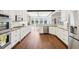 Bright kitchen featuring white cabinets, granite countertops, stainless steel appliances, and hardwood floors at 3530 Horizon Ct, Cumming, GA 30041