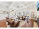 Bright living room with hardwood floors, a stone fireplace, ample seating, and views into an adjoining breakfast area at 3530 Horizon Ct, Cumming, GA 30041