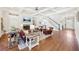 Spacious living room with hardwood floors, coffered ceiling, fireplace, and staircase bathed in natural light, ideal for gatherings at 3530 Horizon Ct, Cumming, GA 30041