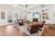 Elegant living room featuring a coffered ceiling, fireplace, built-in shelves, and large windows offering scenic views at 3530 Horizon Ct, Cumming, GA 30041