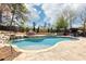 Inviting backyard pool with a waterfall feature and stone surround, perfect for relaxation at 3530 Horizon Ct, Cumming, GA 30041