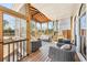 Comfortable screened-in porch with wicker furniture, wooden floors, and views of the serene backyard at 3530 Horizon Ct, Cumming, GA 30041