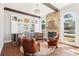 Sitting area with stone fireplace, built in cabinets, leather chairs and pool views at 3530 Horizon Ct, Cumming, GA 30041