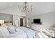 Bright bedroom features vaulted ceilings, chandelier, and white furnishings at 39 Paces West Nw Dr, Atlanta, GA 30327