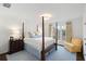 This bright bedroom features a four-poster bed, blue rug and accents, and natural lighting at 39 Paces West Nw Dr, Atlanta, GA 30327