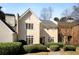 Elegant two-story home featuring a symmetrical design, light stucco, and lush landscaping at 39 Paces West Nw Dr, Atlanta, GA 30327