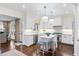 Well-lit kitchen featuring white cabinets, stainless steel appliances, and an island with seating at 39 Paces West Nw Dr, Atlanta, GA 30327