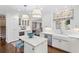 Elegant white kitchen with stainless steel appliances, island seating, and backyard views at 39 Paces West Nw Dr, Atlanta, GA 30327
