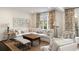 Bright living room with a large sofa, patterned cushions, and warm lighting creating a cozy feel at 39 Paces West Nw Dr, Atlanta, GA 30327