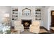Cozy living room with a fireplace, built-in shelves, and comfortable armchairs at 39 Paces West Nw Dr, Atlanta, GA 30327