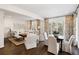 Spacious living room with hardwood floors, neutral furniture, and large windows with decorative curtains at 39 Paces West Nw Dr, Atlanta, GA 30327