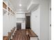 Hallway style mudroom features custom storage lockers, bench, and stainless-steel appliances at 39 Paces West Nw Dr, Atlanta, GA 30327