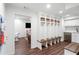 Mudroom with custom lockers, bench, and stainless-steel appliances adjacent to playroom at 39 Paces West Nw Dr, Atlanta, GA 30327