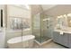 Bathroom featuring freestanding tub, glass-enclosed shower, and vanity at 4089 Hooch River Trl, Suwanee, GA 30024