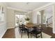 Dining room with hardwood floors, modern lighting, and a view into the entry way at 4089 Hooch River Trl, Suwanee, GA 30024