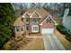 Charming brick home with a manicured lawn, attached garage, and lovely curb appeal at 4089 Hooch River Trl, Suwanee, GA 30024