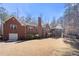 Expansive backyard featuring lush green lawn and a red brick home with a screened-in porch at 9246 W Banks Mill Rd, Winston, GA 30187