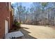 Beautiful, expansive backyard with lawn, trees and the side of a brick house at 9246 W Banks Mill Rd, Winston, GA 30187
