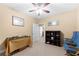 Neutral bedroom with a ceiling fan, a bookcase, model train set, and two chairs at 9246 W Banks Mill Rd, Winston, GA 30187