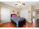 Comfortable bedroom with ceiling fan, wood floors, and closet storage space at 9246 W Banks Mill Rd, Winston, GA 30187