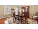 Charming dining room with wooden table set and decorative area rug at 9246 W Banks Mill Rd, Winston, GA 30187