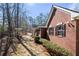 Brick home exterior with shutters, a side yard and trees at 9246 W Banks Mill Rd, Winston, GA 30187