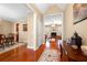 Elegant entryway with gleaming hardwood floors leading to dining room and living spaces at 9246 W Banks Mill Rd, Winston, GA 30187