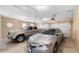 Three-car garage featuring overhead lighting and two parked cars at 9246 W Banks Mill Rd, Winston, GA 30187