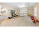 Spacious garage with shelving units, utility sink, and a roll-up door at 9246 W Banks Mill Rd, Winston, GA 30187