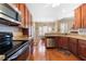 Spacious kitchen with cherry wood cabinetry, granite countertops, and stainless appliances at 9246 W Banks Mill Rd, Winston, GA 30187