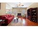 Comfortable living room featuring a brick fireplace, hardwood floors, and neutral paint at 9246 W Banks Mill Rd, Winston, GA 30187