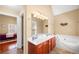 Well-lit main bathroom with double sinks and a jetted tub at 9246 W Banks Mill Rd, Winston, GA 30187