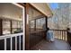 View of a screened-in porch with wooden floors, a table and chairs, and ceiling fan at 9246 W Banks Mill Rd, Winston, GA 30187