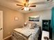 Charming bedroom with a patterned comforter, ceiling fan, and ample natural light at 252 Berkley Dr, Villa Rica, GA 30180