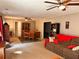 Spacious living room featuring a large sofa, ceiling fan, and dining area in the background at 252 Berkley Dr, Villa Rica, GA 30180