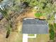 An aerial view of the property with a clear view of the roof, yard, and surrounding landscape at 7613 Suwannee Ct, Jonesboro, GA 30236