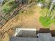 Aerial view of the home's backyard featuring a patio and shed, all surrounded by trees at 7613 Suwannee Ct, Jonesboro, GA 30236