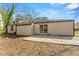 Home's backyard features a concrete patio and sliding glass door at 7613 Suwannee Ct, Jonesboro, GA 30236