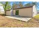 Exterior view of home's backyard with a concrete patio and sliding glass door at 7613 Suwannee Ct, Jonesboro, GA 30236