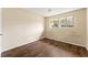 Bedroom with wood floors, natural light from two windows, and standard closet at 7613 Suwannee Ct, Jonesboro, GA 30236