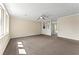 Spacious living room with plush carpeting, neutral tones, and abundant natural light from large windows at 7613 Suwannee Ct, Jonesboro, GA 30236