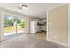 View of a living space featuring a kitchen space, a sliding glass door and carpet flooring at 7613 Suwannee Ct, Jonesboro, GA 30236