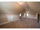 Spacious attic features neutral walls and carpet, perfect for a bonus room at 85 Providence Pkwy, Covington, GA 30014