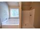 Bright bathroom features a soaking tub and a separate shower at 85 Providence Pkwy, Covington, GA 30014