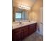 Elegant bathroom with double vanity, wood cabinets, and granite countertops at 85 Providence Pkwy, Covington, GA 30014