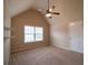 Bright bedroom features a ceiling fan, neutral walls, and a large window at 85 Providence Pkwy, Covington, GA 30014