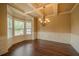 Traditional dining room features hardwood floors, large bay window, chandelier, and wainscoting at 85 Providence Pkwy, Covington, GA 30014